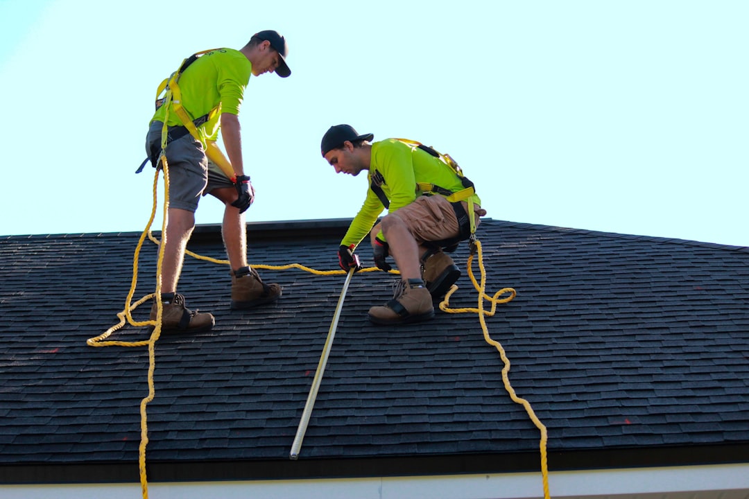 Professional roofing contractor installing high-quality shingles on a residential roof, showing expert craftsmanship and proper flashing